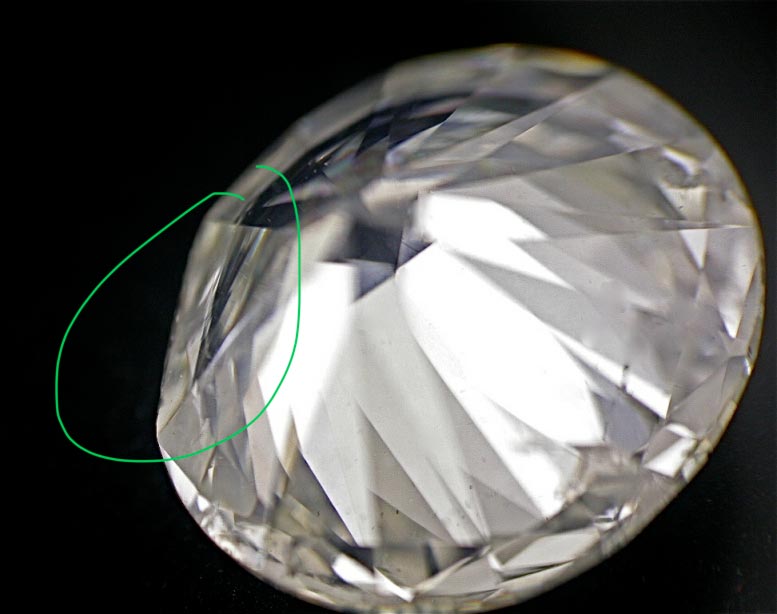 Diamond with a large section removed in order to improve its clarity grade. Diamond with a large section removed in order to improve its clarity grade.