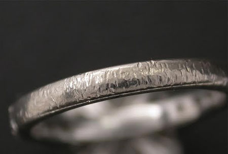 Damaged ring band with deep indentations