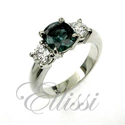 “Alexia” features a central teal green cushion cut sapphire.