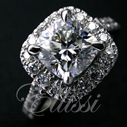 “Lily” Cushion brilliant claw set halo with diamond set band.