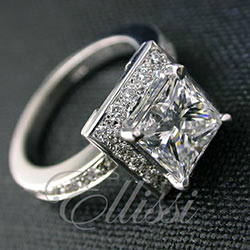 "Isolda" Princess cut diamond in a square halo ring.