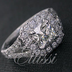 "Tauri" Cushion cut diamond halo cluster with a split band.