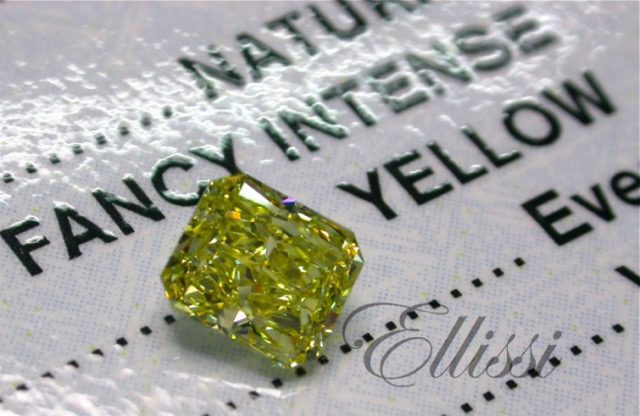 Fancy intense yellow radiant cut diamond photographed on its GIA certificate
