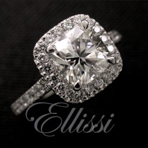 Cushion cut halo ring set with round brilliant cut diamonds in the halo and band