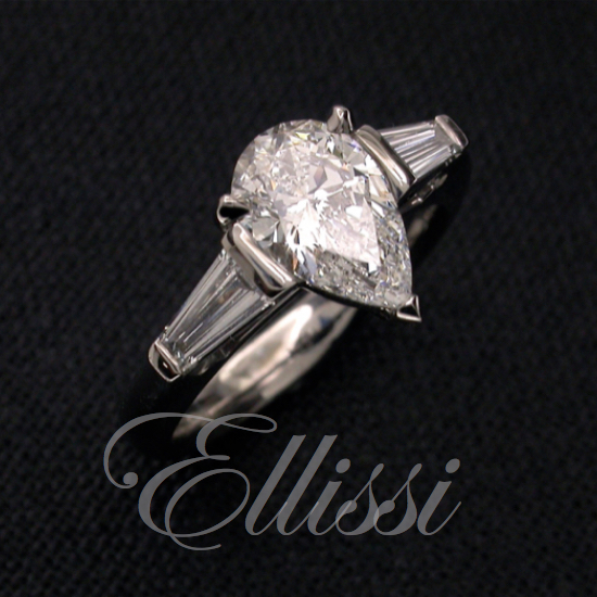 Pear cut diamond flanked by matching tapered baguette diamonds